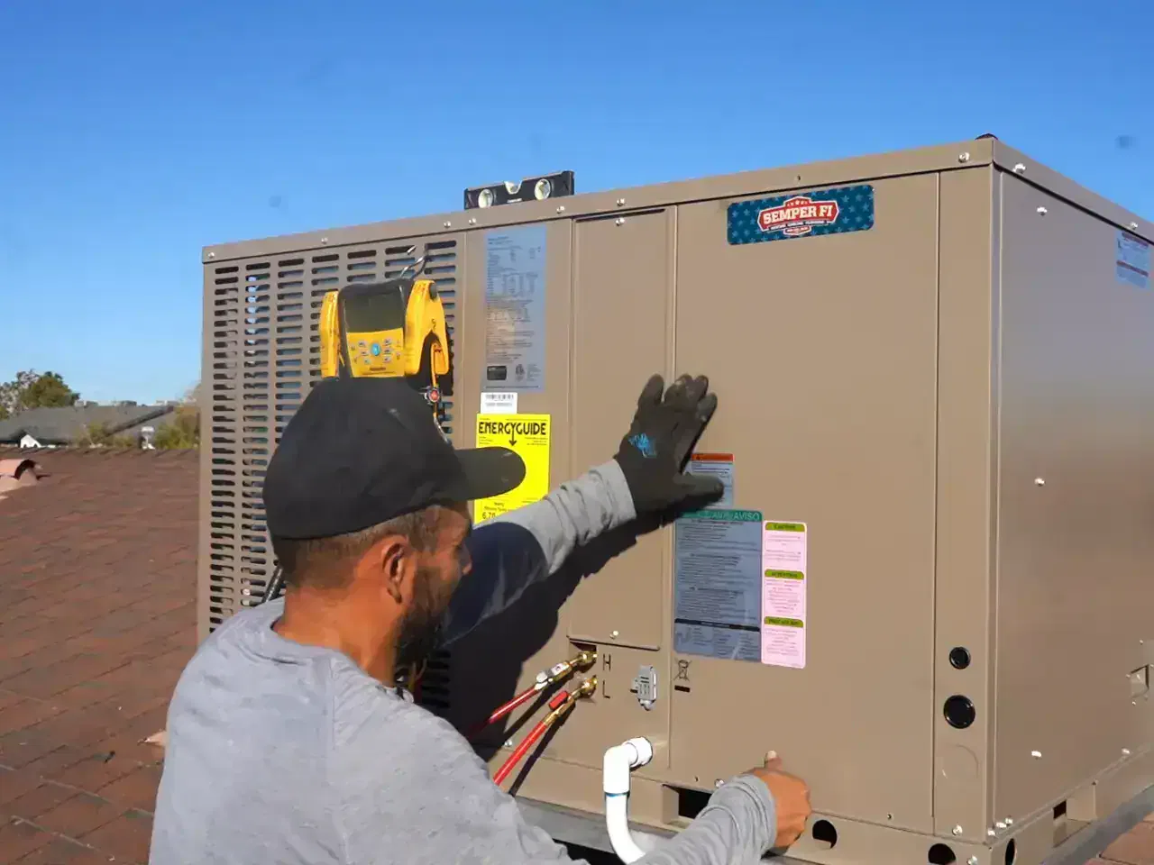 HVAC technician inspecting and repairing a residential air conditioning unit.